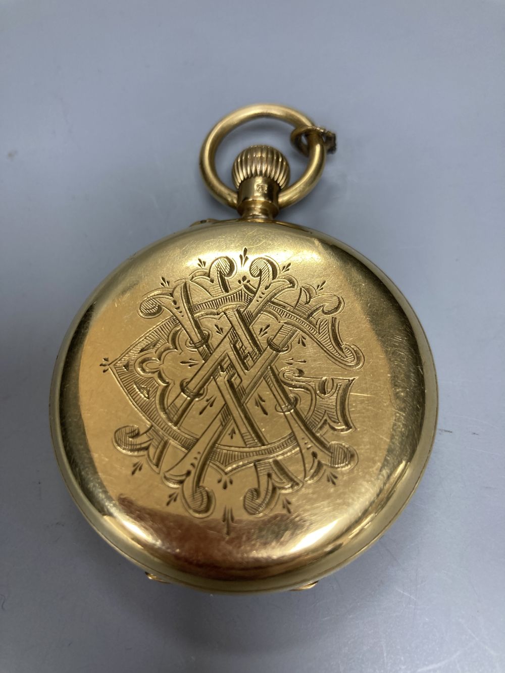 An Edwardian 18ct gold open face keywind lever pocket watch, the case back with engraved monogram,